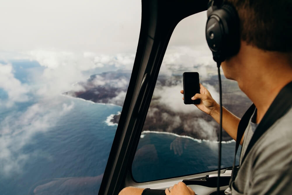 Passenger takes in Puna coastline from helicopter